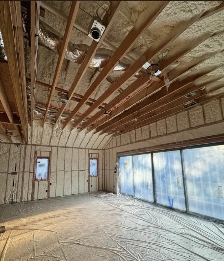 Interior walls and ceiling insulated with spray foam during new construction in Lake Arbor
